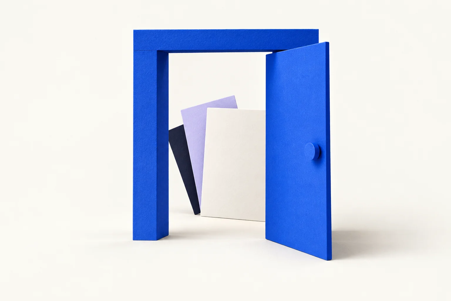 An open cobalt-blue paper doorway reveals a fan of blank cards in off-white, lavender, and ink.